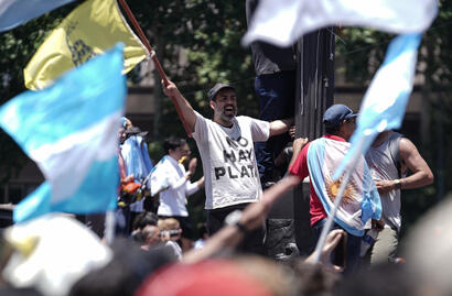 Un manifestante de La libertad avanza viste una remera que dice "no hay plata" el día que asume Milei su presidencia 2023